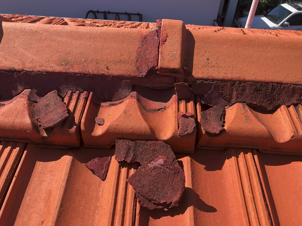 Damaged broken roof ridge tile pointing