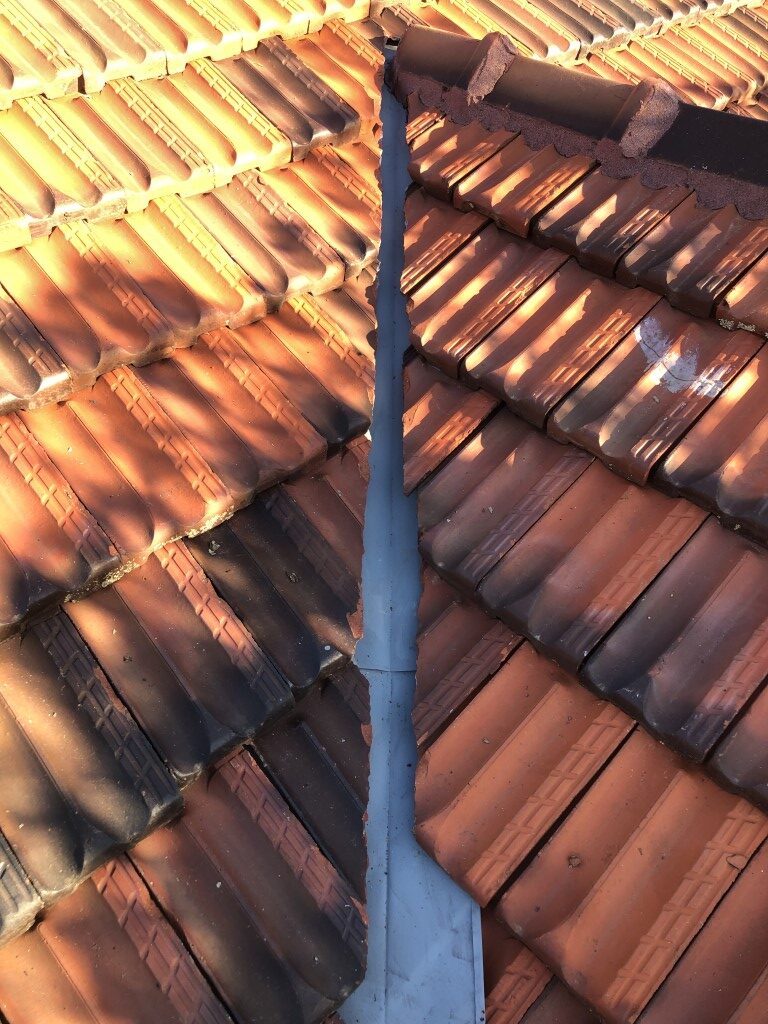 Valley gutter coated with zinc gal sacrificial primer after removing surface rust