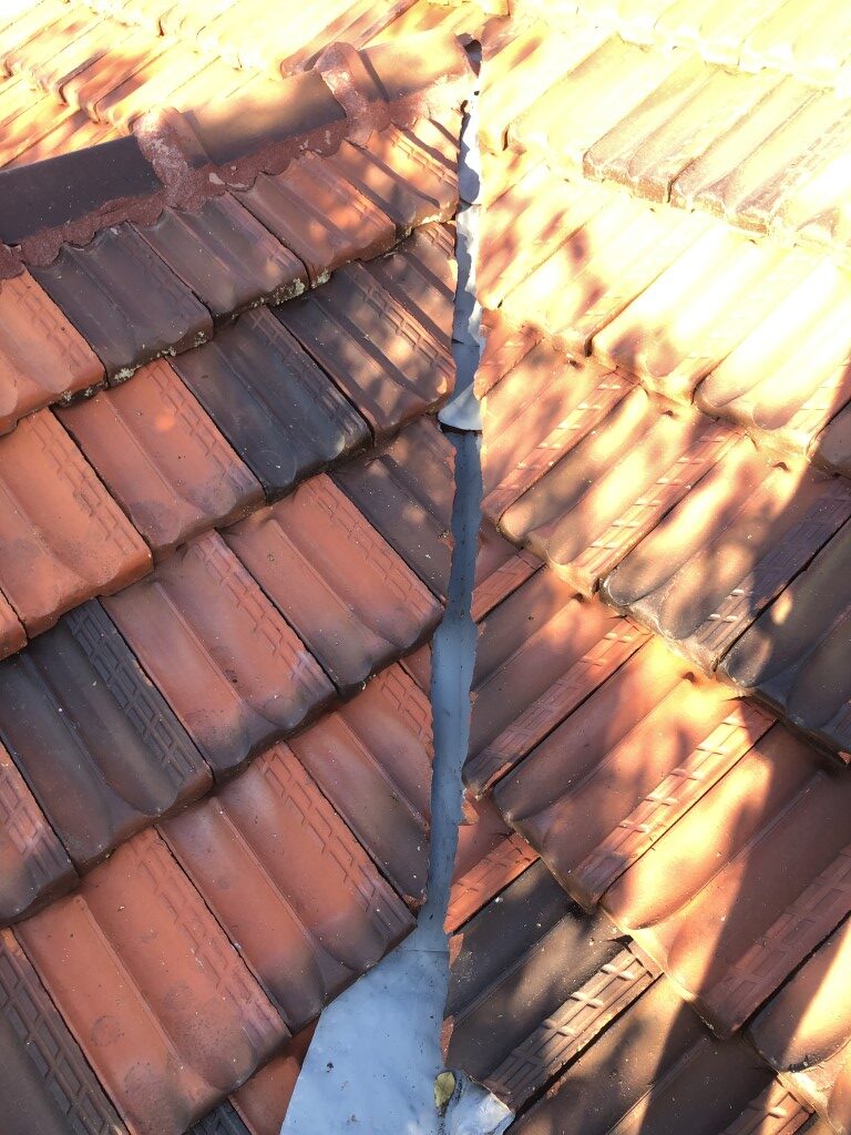 Valley gutter coated with zinc gal sacrificial primer after removing surface rust