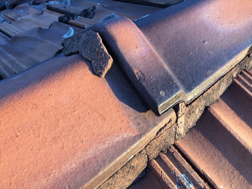 Non-flexible pointing damaged and broken off from the ridge tile