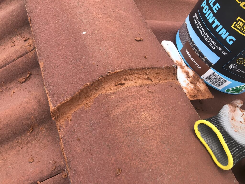 Completed pointing to repair a crack in the roof tile cement