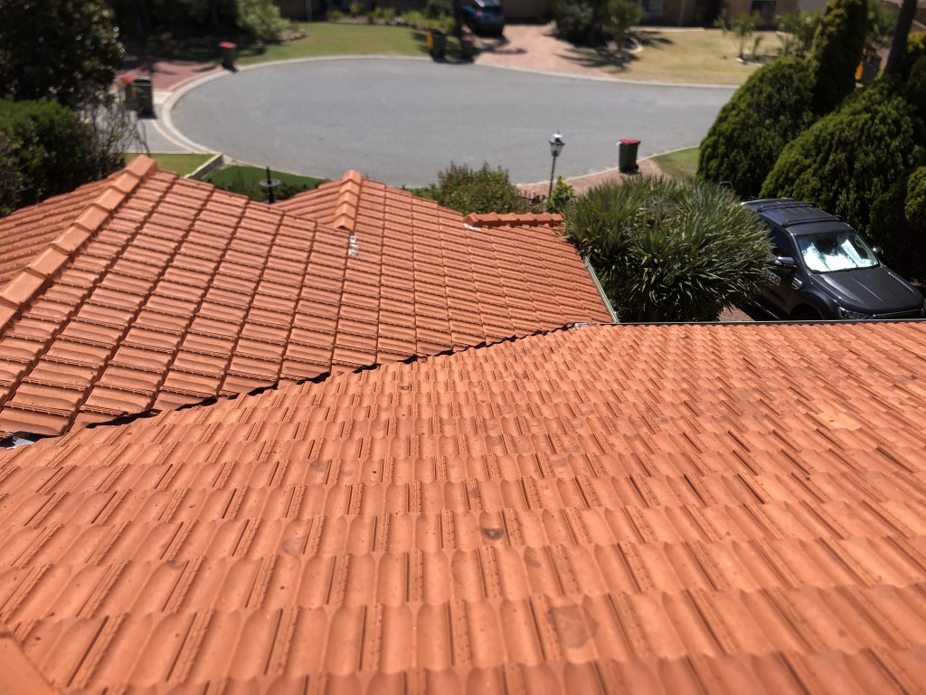 Cleaned terracotta tiled roof. Lichen cleaned off with high pressure washing.